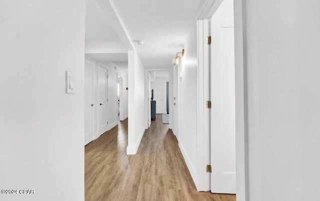 5801 Thomas Dr Unit 501, Panama City, FL 32408 - hallway featuring light wood finished floors and baseboards