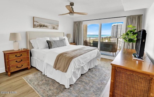 bedroom featuring ceiling fan, light hardwood / wood-style floors, and access to exterior