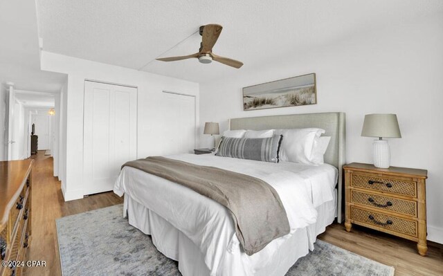 5801 Thomas Dr Unit 501, Panama City, FL 32408 - bedroom with wood finished floors, ceiling fan, and two closets