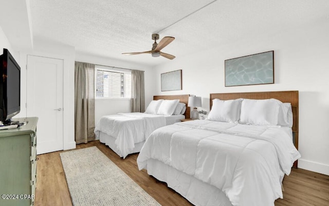 5801 Thomas Dr Unit 501, Panama City, FL 32408 - bedroom with wood finished floors, a textured ceiling, and a ceiling fan