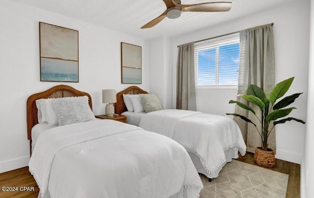 bedroom with hardwood / wood-style flooring and ceiling fan