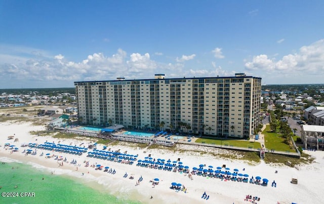 bird's eye view featuring a water view and a beach view