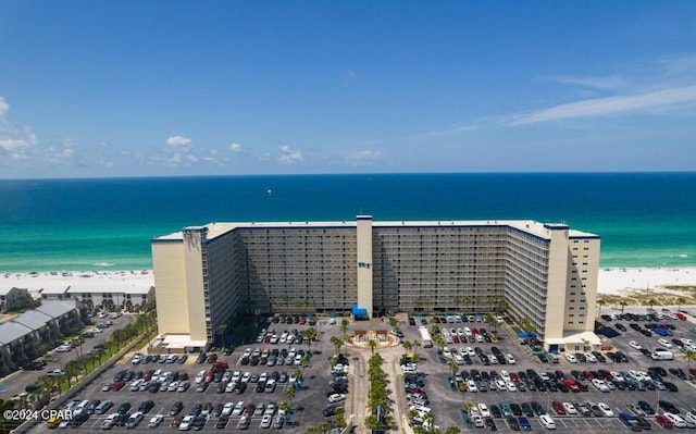 drone / aerial view featuring a water view and a beach view