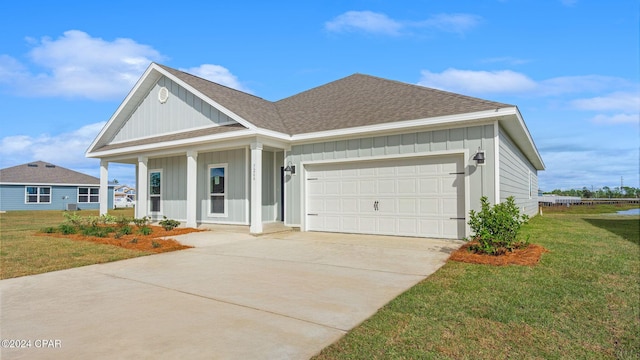 view of front of property featuring a garage and a front yard