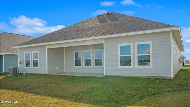 back of house with a patio area, a yard, and central air condition unit