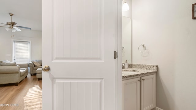 bathroom with vanity, hardwood / wood-style flooring, and ceiling fan