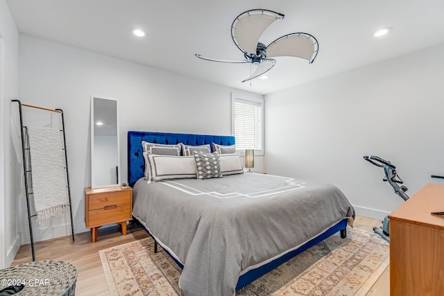 bedroom with hardwood / wood-style floors and ceiling fan