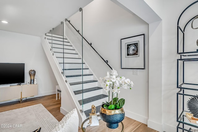 staircase with wood-type flooring