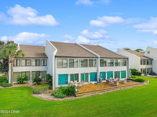 back of property with a yard and a patio area