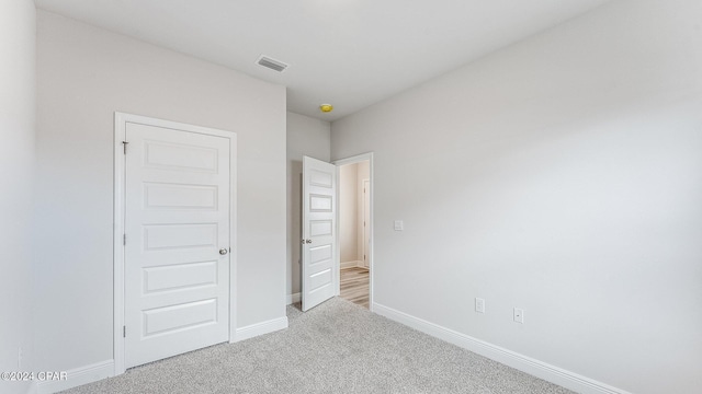 unfurnished bedroom featuring light colored carpet