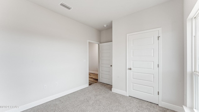 unfurnished bedroom featuring light colored carpet