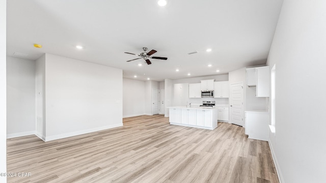 interior space with ceiling fan and light hardwood / wood-style floors