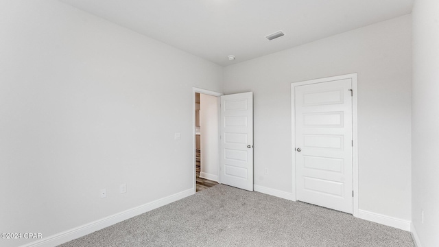 unfurnished bedroom featuring carpet floors and a closet