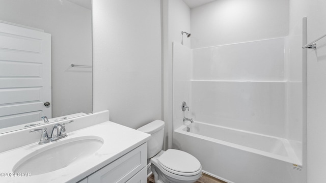 full bathroom featuring hardwood / wood-style flooring, vanity, shower / bath combination, and toilet