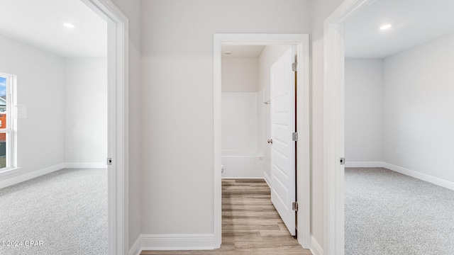 hallway featuring light carpet