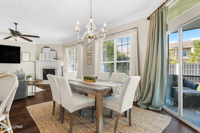 dining room featuring ornamental molding, dark hardwood / wood-style floors, a textured ceiling, and ceiling fan with notable chandelier