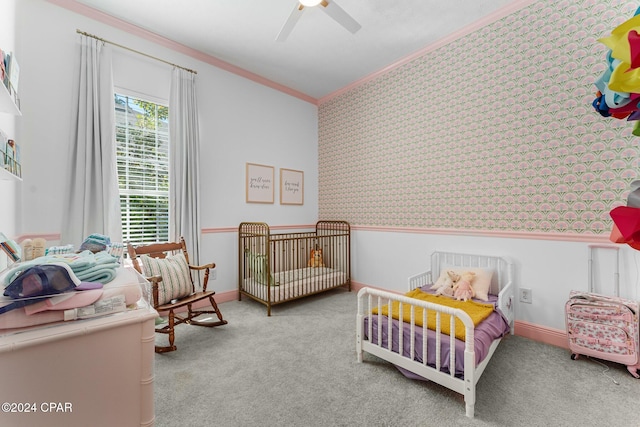 carpeted bedroom featuring crown molding and ceiling fan