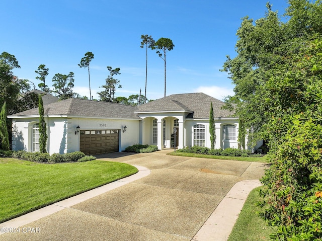 view of front facade with a front lawn and a garage