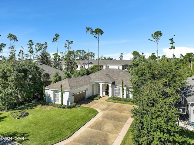 view of front of home featuring a front yard and a garage