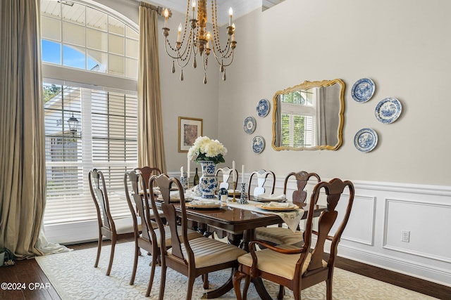 dining area featuring crown molding, an inviting chandelier, and hardwood / wood-style floors