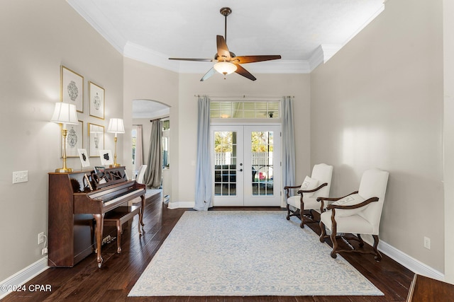 sitting room with ornamental molding, french doors, dark hardwood / wood-style floors, and ceiling fan