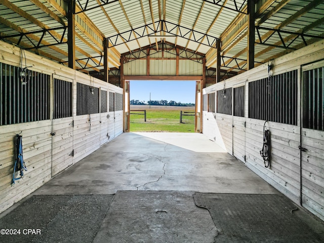 view of horse barn featuring a rural view