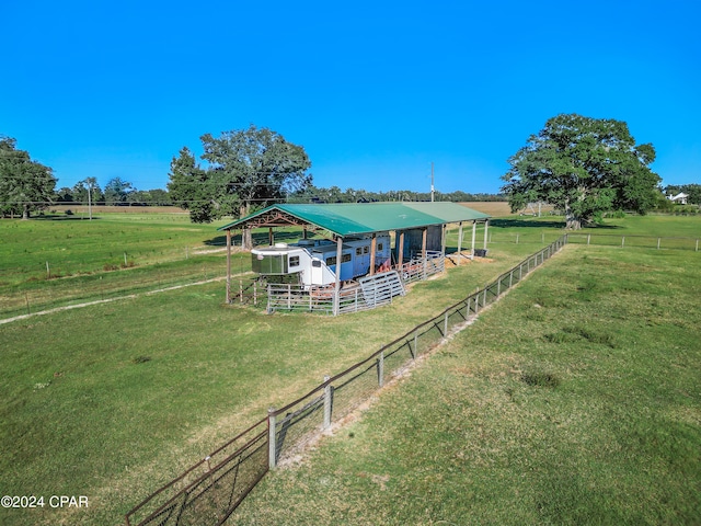 rear view of property with an outbuilding and a rural view