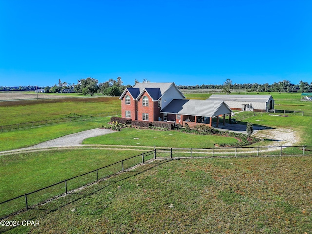 view of front of property featuring a rural view and a front lawn