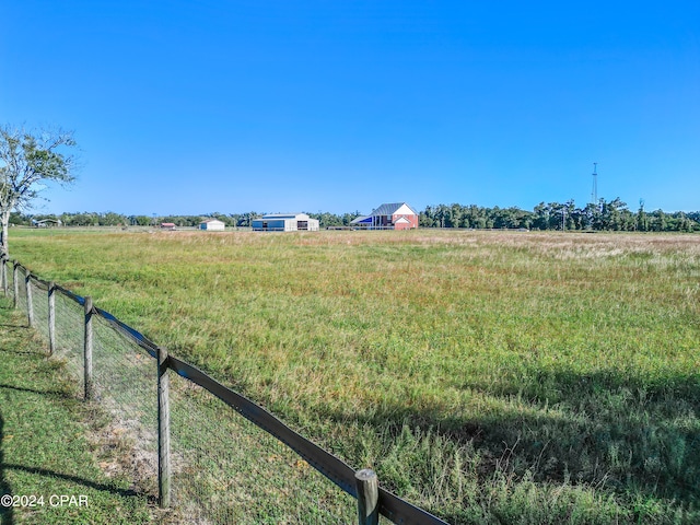 view of yard with a rural view