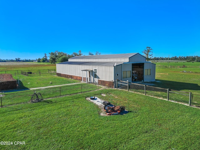 view of outbuilding featuring a lawn and a rural view