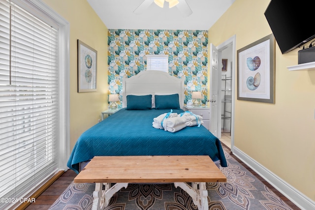 bedroom with ceiling fan, hardwood / wood-style flooring, and multiple windows