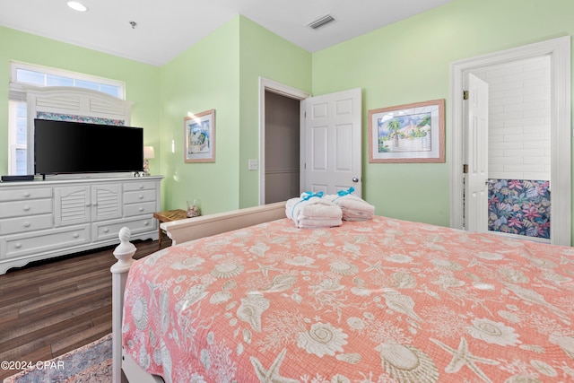 bedroom with dark wood-type flooring