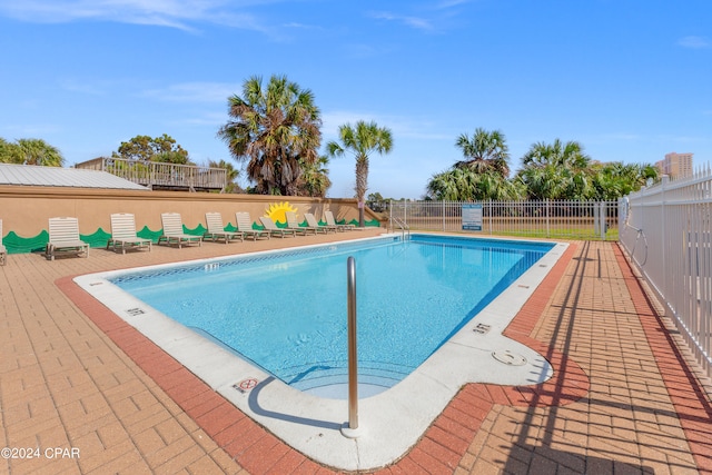 view of swimming pool featuring a patio area