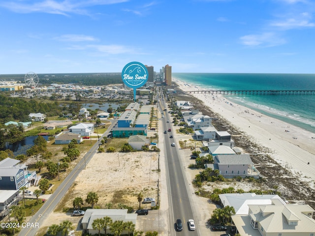 drone / aerial view featuring a water view and a view of the beach