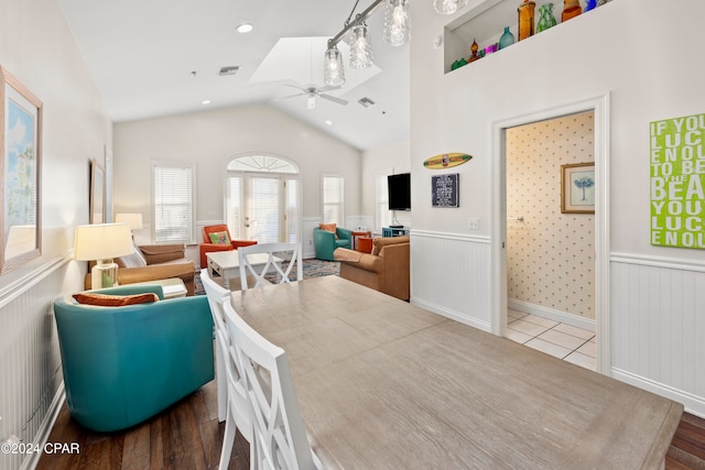 dining room featuring french doors, wood-type flooring, vaulted ceiling, and ceiling fan