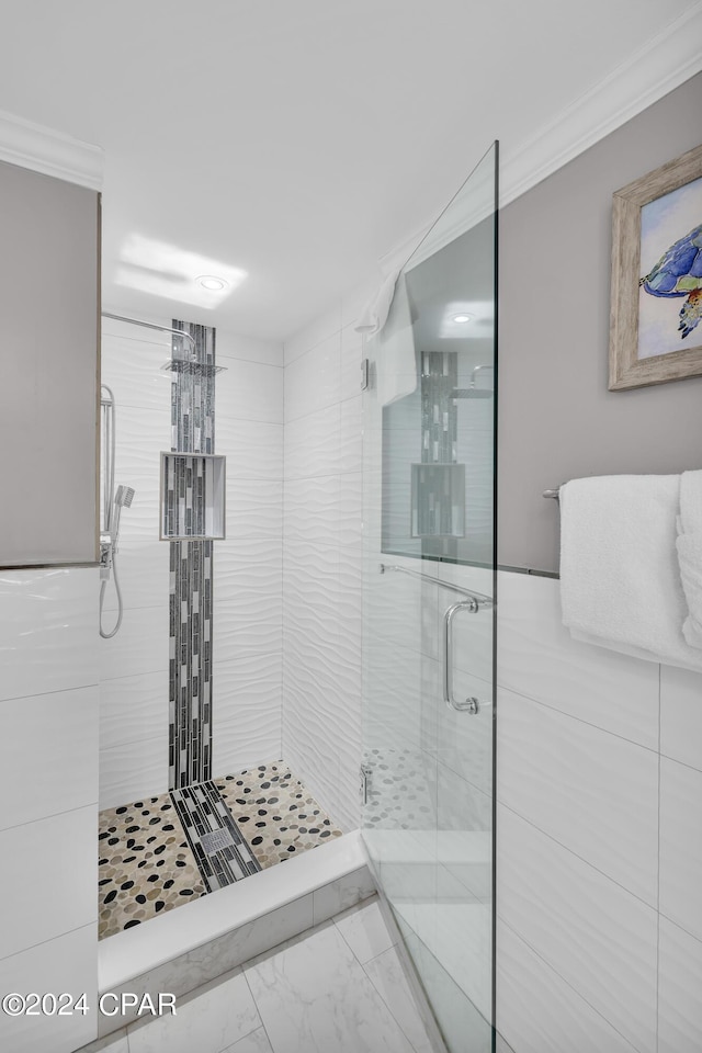 bathroom with ornamental molding and a shower with door