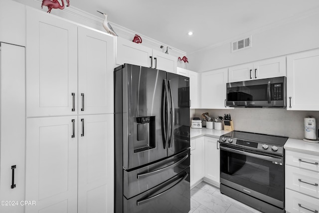 kitchen featuring crown molding, stainless steel appliances, and white cabinets