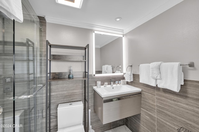 bathroom with ornamental molding, toilet, a shower with door, and vanity