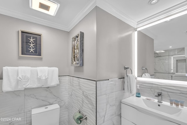 bathroom with crown molding, vanity, toilet, and tile walls