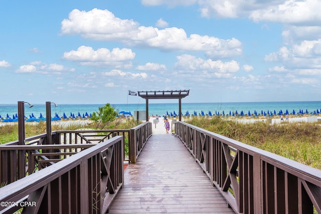 view of home's community with a beach view and a water view