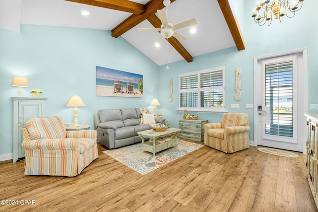 living room featuring ceiling fan with notable chandelier, light wood-type flooring, and vaulted ceiling with beams