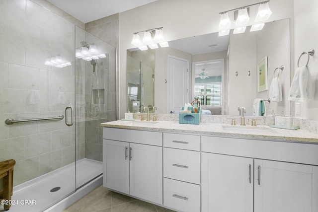 bathroom with an enclosed shower, tile patterned flooring, and vanity