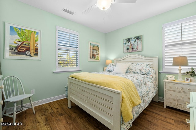 bedroom with ceiling fan and dark hardwood / wood-style floors