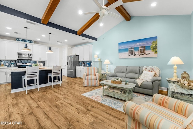 living room featuring ceiling fan, vaulted ceiling with beams, and light hardwood / wood-style flooring