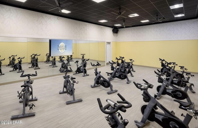 exercise room with carpet and a drop ceiling