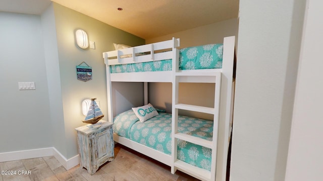 bedroom with baseboards and wood finished floors