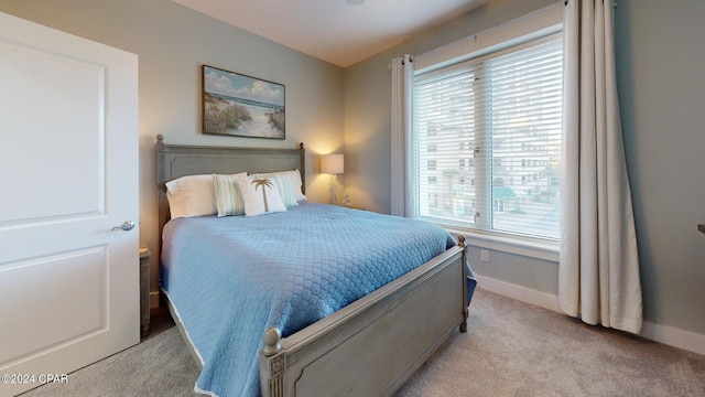 carpeted bedroom featuring baseboards