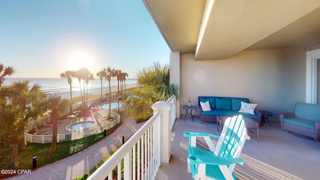 balcony with an outdoor hangout area and a water view