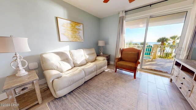 living room with light wood-type flooring and ceiling fan