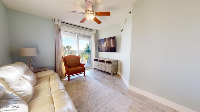 living room featuring light wood-type flooring and ceiling fan